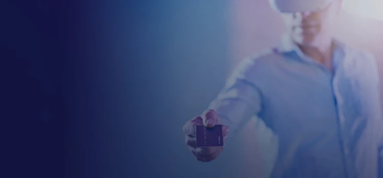 A person presenting a credit card while wearing a VR headset