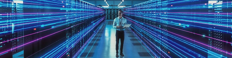 Person walking through server racks with glowing data streams