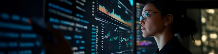 A woman wearing a headset is looking at a screen, appearing concentrated on her digital interaction.