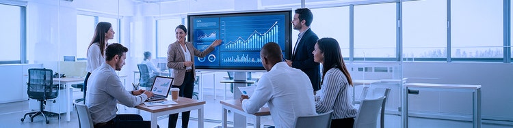 Business team reviews AI-driven financial data in modern office.