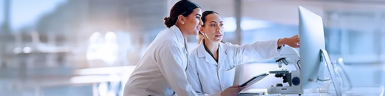 two women looking at a screen