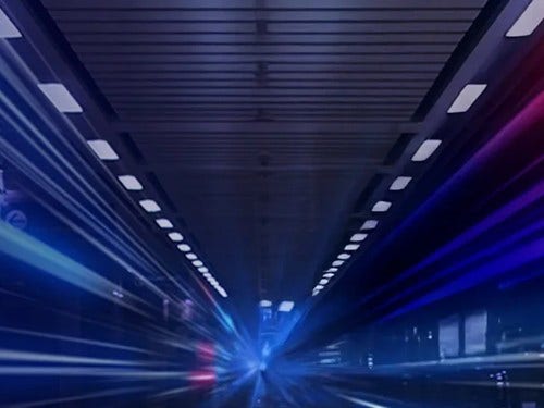 Futuristic tunnel with blue and red light streaks, creating a dynamic sense of speed and motion.
