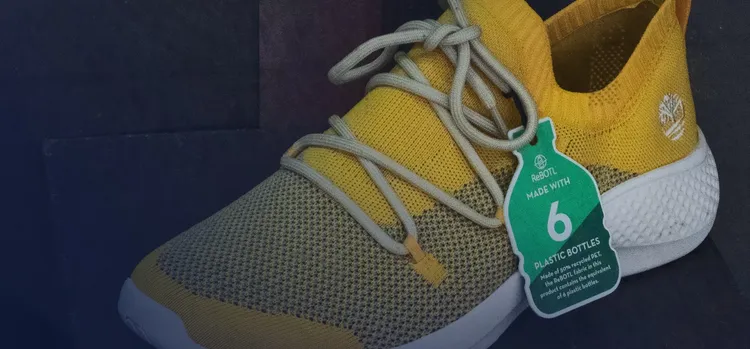 A shoe of yellow and brown color with tag.