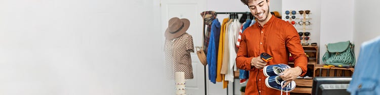 Boy scanning barcode of the shoe in store