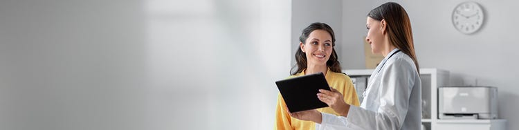 One person showign a tablet to another person