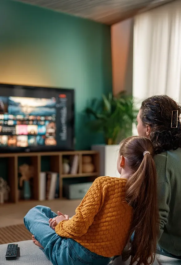 A woman and a child using a home streaming service, representing modern media and entertainment experiences.