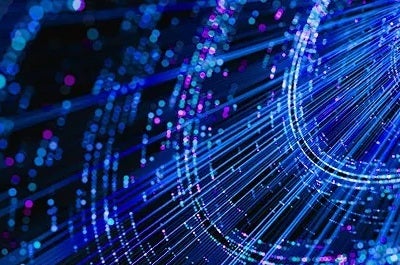 Abstract digital illustration of glowing blue and pink light streaks and particles forming flowing lines against a dark background, evoking data or network connectivity.