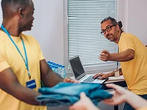 Two male nonprofit workers having a conversation.