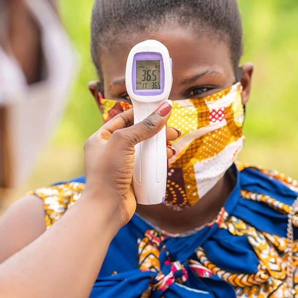 A child getting her temperature checked