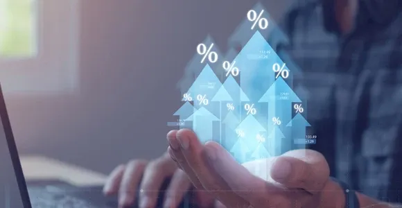 Hand holding digital arrows showing rising percentage icons