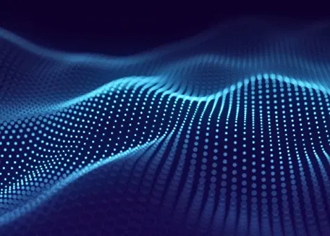 Abstract digital wave made of glowing blue dots on a dark background, representing data and technology.