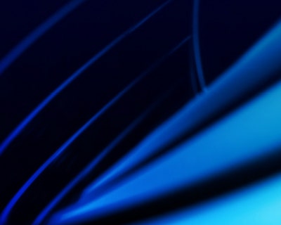 Flowing purple-blue digital waves with glowing particle texture